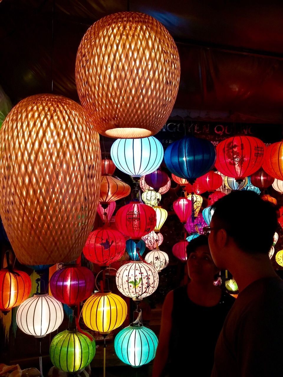 illuminated, indoors, lighting equipment, celebration, night, leisure activity, decoration, lifestyles, lantern, hanging, multi colored, ceiling, cultures, tradition, traditional festival, balloon, men, in a row, arts culture and entertainment