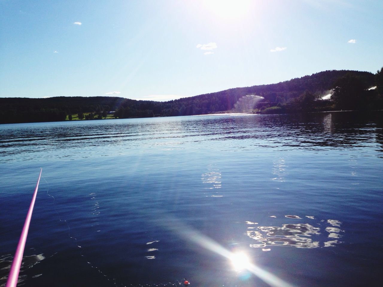 water, sun, tranquil scene, mountain, scenics, tranquility, beauty in nature, sunlight, sunbeam, reflection, lake, lens flare, sky, nature, idyllic, mountain range, blue, outdoors, sunny, non-urban scene