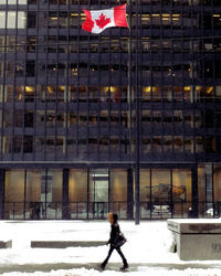 Woman walking in building during winter