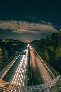 High angle view of light trails on highway against sky