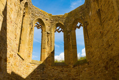 Low angle view of old building against sky