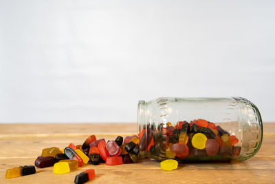 Close-up of multi colored bottles on table