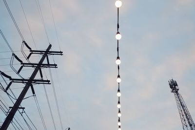 Low angle view of electricity pylon against sky