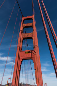 Low angle view of suspension bridge against sky