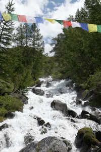 Low angle view of waterfall against sky