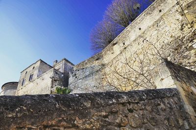 Low angle view of built structure against blue sky