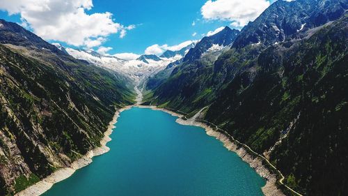 Scenic view of river amidst mountains against sky