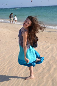 Portrait of playful young woman at beach