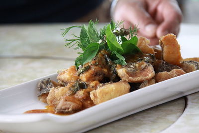 Close-up of food by hand on table