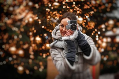 Portrait of man photographing with camera