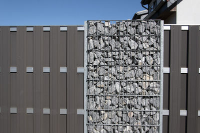 A gray gabion fence protects against prying eyes on the roadside in bünde, east westphalia