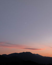 Scenic view of silhouette mountains against sky during sunset