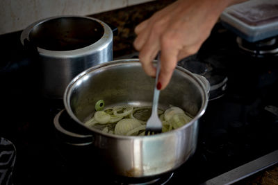 Onions being fried in the pan. food seasoning.