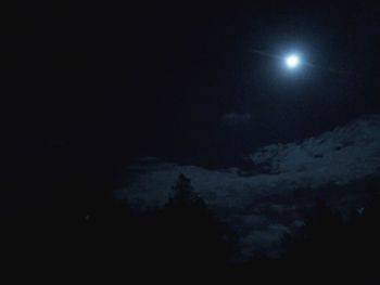 Low angle view of moon in sky at night