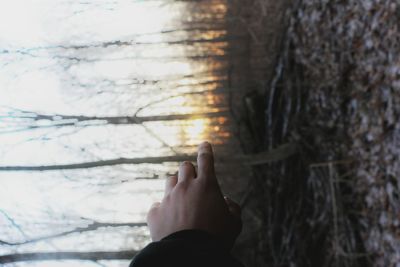 Low section of person standing in water