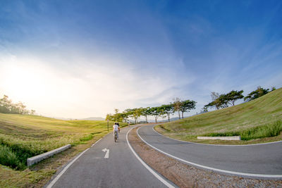 Road amidst trees against sky