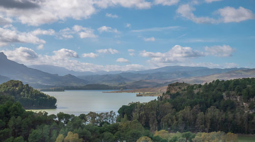 Scenic view of lake and mountains against sky