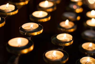 High angle view of lit tea light candles