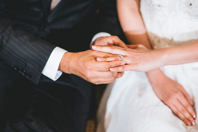 Midsection of couple holding hands