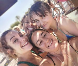 Portrait of smiling friends enjoying at home