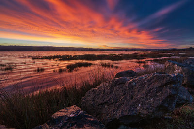 Scenic view of lake against sky during sunset