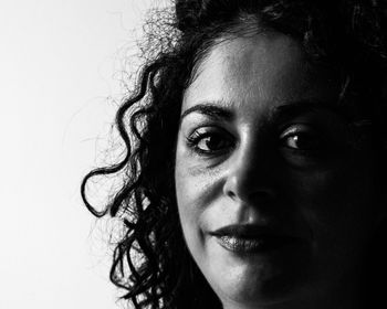 Close-up portrait of woman against white background