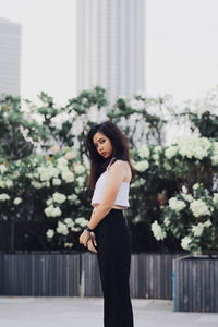 Portrait of woman standing against wall