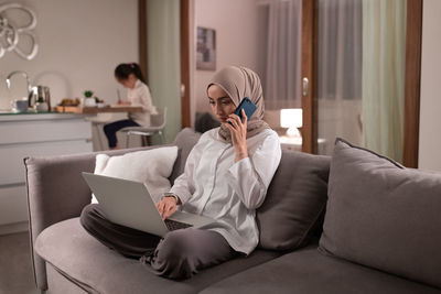 Muslim mother working at home