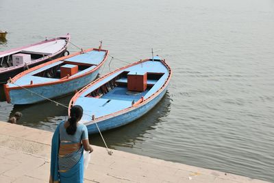 Rear view of woman standing on sea