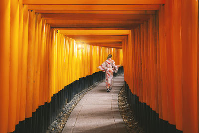 Woman walking in corridor of building