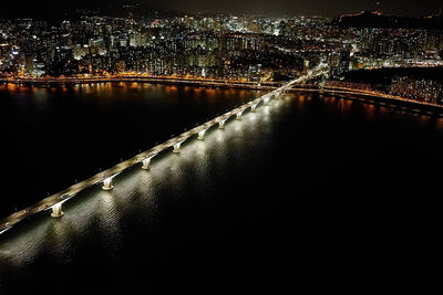 High angle view of illuminated bridge over river at night