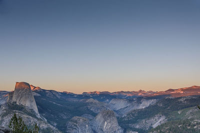 Scenic view of mountains against clear sky during sunset