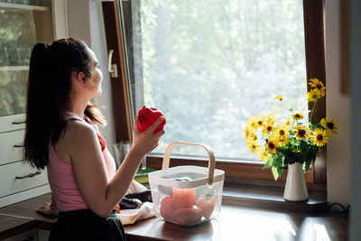 Vegan food and health. vegans eat. young latina woman holding red bell pepper near vegetables on