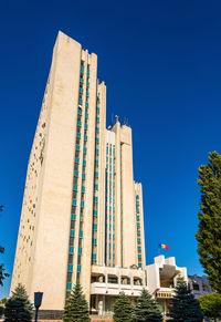 Low angle view of buildings against clear blue sky