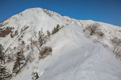 Scenic view of snowcapped mountains against clear sky