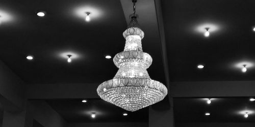 Low angle view of illuminated pendant lights hanging from ceiling