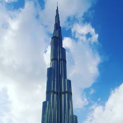 Low angle view of buildings against cloudy sky