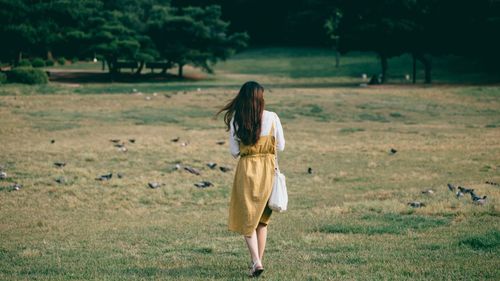 Full length of woman walking on field