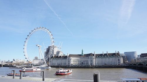 Ferris wheel in city against sky