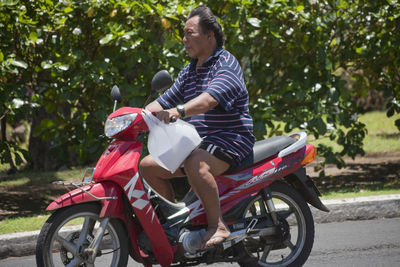 Rear view of man riding motorcycle