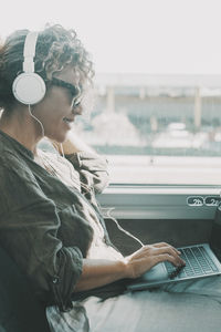 Young woman using laptop at home