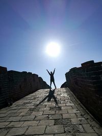 Silhouette man on old ruin against sky