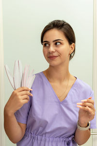 Portrait of young woman holding flower