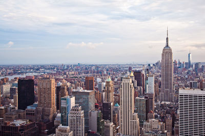 Empire state building with cityscape against sky