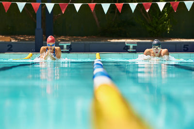 Cropped image of man swimming in pool