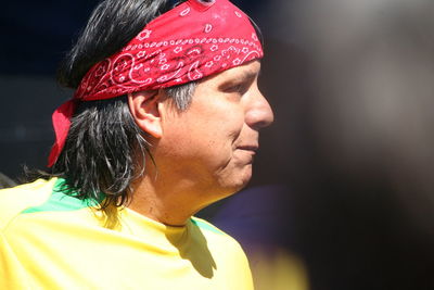 Close-up of man wearing red bandana