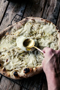 Cropped hand of person preparing food