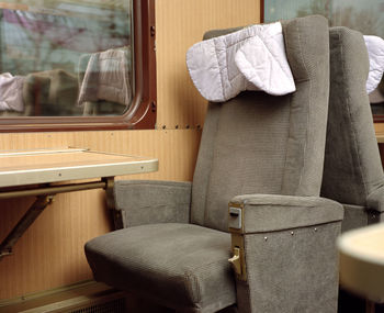 Seat and table by window in train