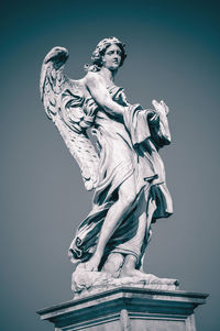 Low angle view of statue against sky