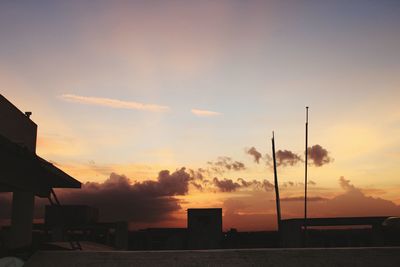 Silhouette buildings against sky during sunset